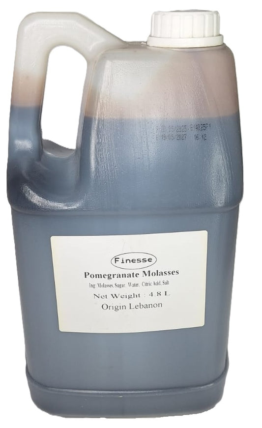 Jug of Finesse Pomegranate Molasses with a white label on a white background